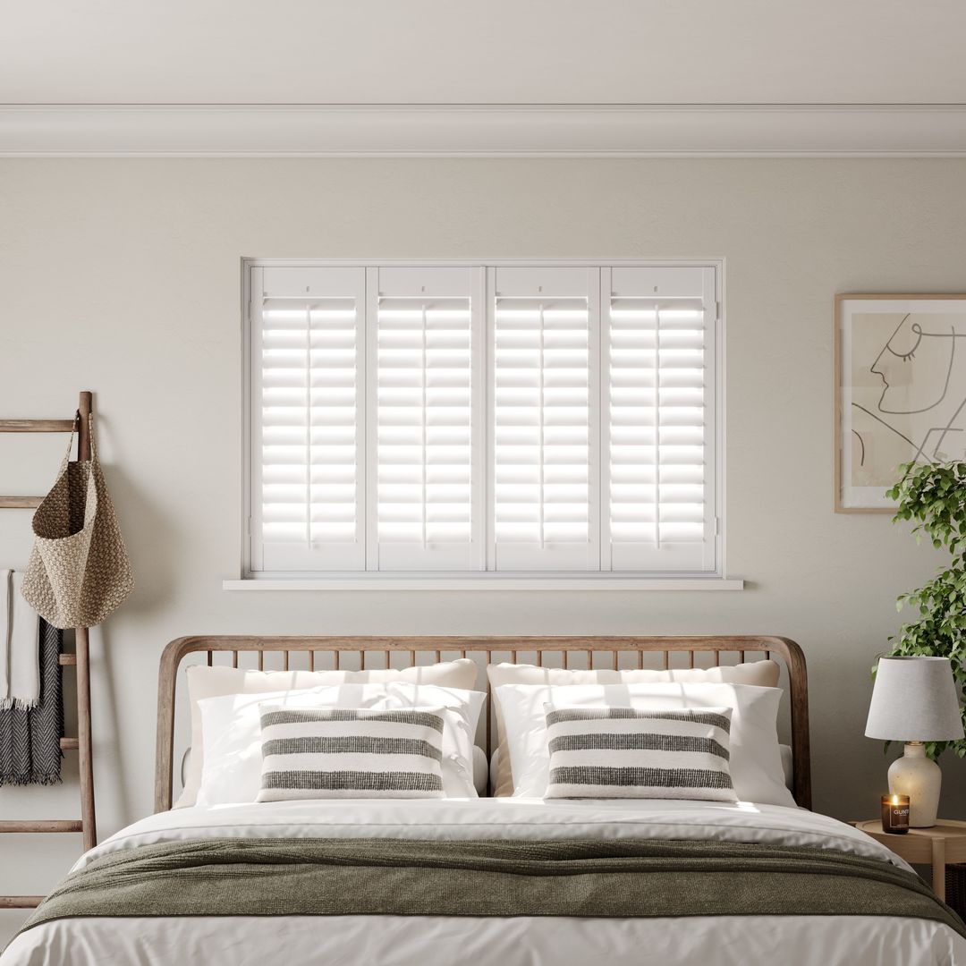 A modern neutral bedroom with Vivid White full height wooden shutters